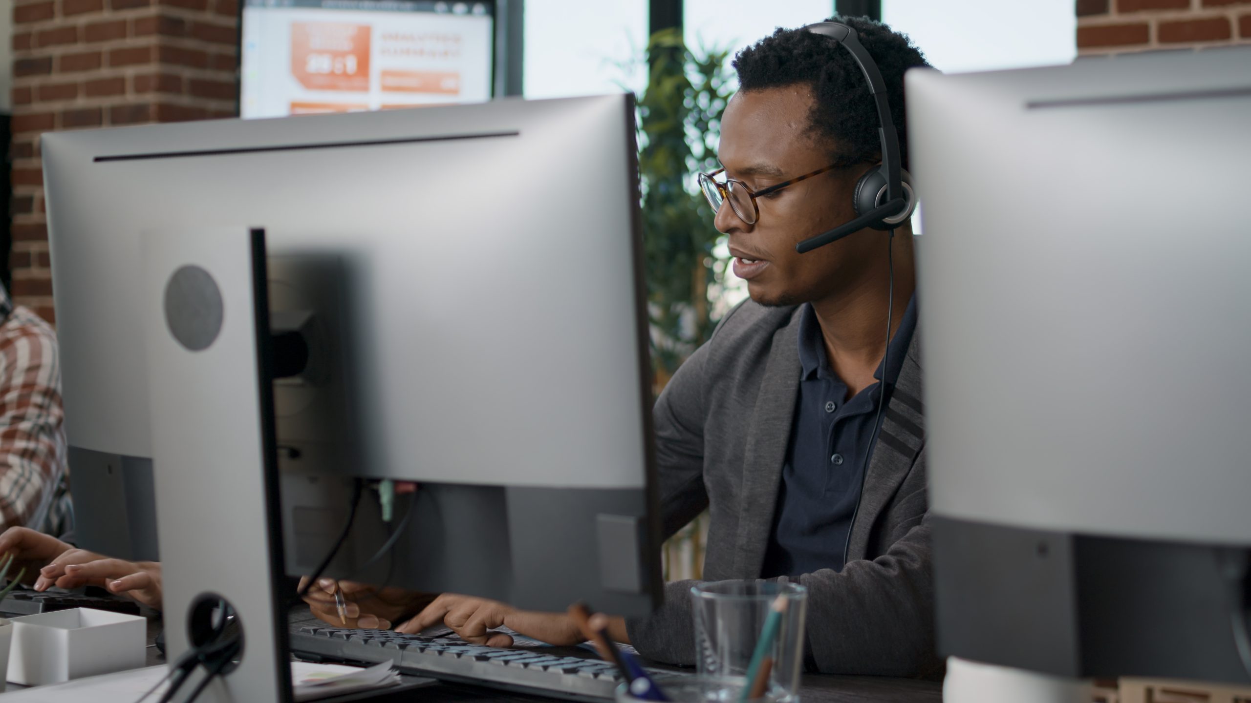 African american employee using headset at customer service